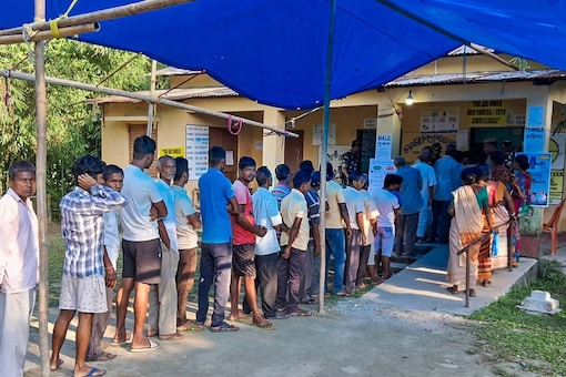 Voters wait to cast their vote during the bypoll to Dhupguri assembly seat, in West Bengal's Jalpaiguri district on September 5. (Image: PTI)
