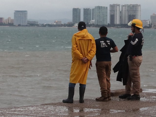 Civil Protection personnel stand by the sea in Puerto Vallarta, Jalisco State, Mexico, as Hurricane Lidia came ashore near this popular beach resort in the Mexican Pacific coast. (Image: AFP)