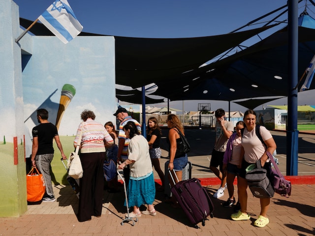 People queue as Israelis are evacuated from the southern town of Sderot, near Israel's border with Gaza, October 15, 2023. (Reuters)