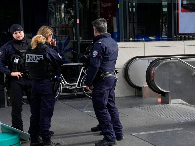 Police officers patrol by a subway station after a woman allegedly made threatening remarks on a train. (Image: AP Photo)