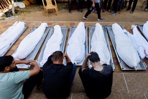 People react next to bodies of Palestinians who were killed in an Israeli strike, at the morgue of Nasser hospital, amid the ongoing conflict between Israel and the Palestinian group Hamas, in Khan Younis in the southern Gaza Strip. (Image: Reuters)