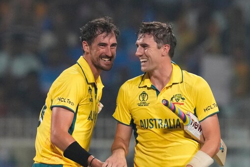 Mitchell Starc (left) and Pat Cummins celebrate Australia's semi-final win. (AP Photo)