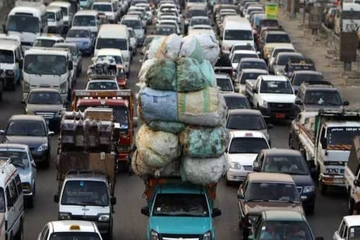 Overloaded vehicles and those with loads protruding/hanging are a traffic hazard, risking accidents for themselves and other road users. Representational image/Reuters