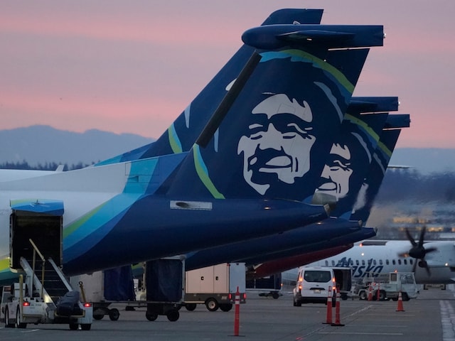 Alaska Airlines planes are shown parked at gates at sunrise, March 1, 2021, at Seattle-Tacoma International Airport in Seattle. (AP Photo)
