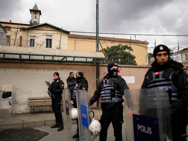 Turkish police officers stand guard in a cordoned off area outside the Santa Maria church, in Istanbul, Turkey, Sunday, Jan. 28, 2024. (AP)