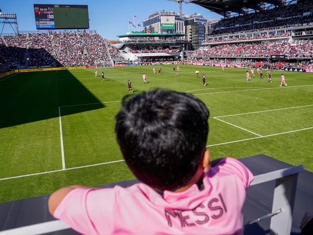 A fan wearing a Lionel Messi jersey watches the second half of an MLS soccer match between DC United and Inter Miami. (AP Photo)