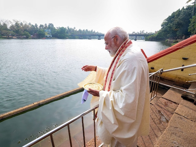 Prime Minister Narendra Modi feeds fish during a visit to a Kerala temple in January this year. He is expected to be in the state again on March 15 and 17. (PTI)