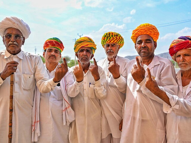 Voters show their fingers marked with indelible ink after casting their votes for the second phase of Lok Sabha polls, in Ajmer on April 26, 2024. (PTI)