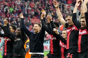 FILE - Leverkusen's head coach Xabi Alonso, centre, celebrates with his team after winning the German Bundesliga soccer match between Bayer Leverkusen and TSG Hoffenheim at the BayArena in Leverkusen, Germany, on March 30, 2024. Excitement was building in Leverkusen, Germany on Sunday ahead of local team Bayer Leverkusen’s expected Bundesliga title win after an outstanding season so far. (AP Photo/Martin Meissner, File)