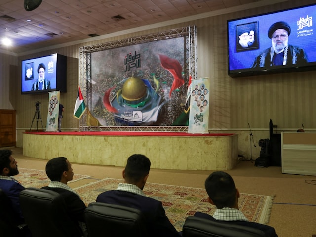 Supporters of Iraq Shi'ite armed groups watch a televised speech by Iranian President Ebrahim Raisi, ahead of Al-Quds (Jerusalem) Day, in Baghdad, Iraq. (Image: Representative/Reuters)