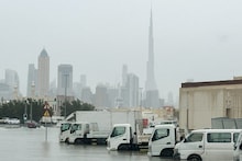 Vehicles stand in flood water caused by heavy rains with the Burj Khalifa tower visible in the background, in Dubai, United Arab Emirates. (Image: Reuters)