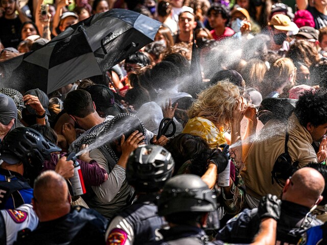 A state trooper pepper sprays pro-Palestinian protesters, during the ongoing conflict between Israel and Hamas, after police vehicles were blocked at the University of Texas, April 29. (Reuters)