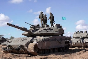 Israeli soldiers standing atop a main battle tank as part of the Givati Brigade operating in eastern Rafah in the southern Gaza Strip amid the ongoing conflict in the Palestinian territory between Israel and Hamas. (Image: AFP)