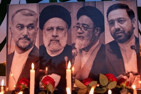 A view of candles lit to offer condolences over the deaths of Iran's President Ebrahim Raisi and others, outside the Iranian embassy, in Baghdad, Iraq. (Image: Reuters)