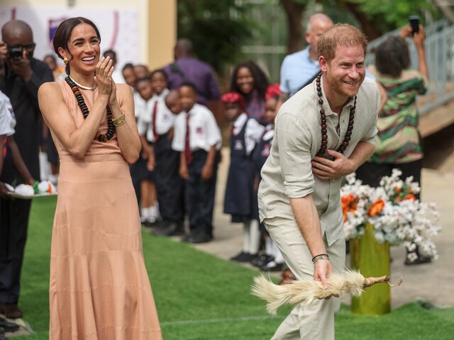 Britain's Prince Harry (R), Duke of Sussex, and Britain's Meghan (L), Duchess of Sussex, take part in activities as they arrive at the Lightway Academy in Abuja on May 10, 2024. (AFP)