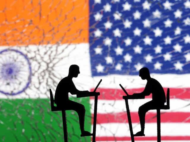 The Indian flag, the U.S. flag and people miniatures with laptops are seen through broken glass in this illustration taken March 10, 2024. (Reuters/Illustration)