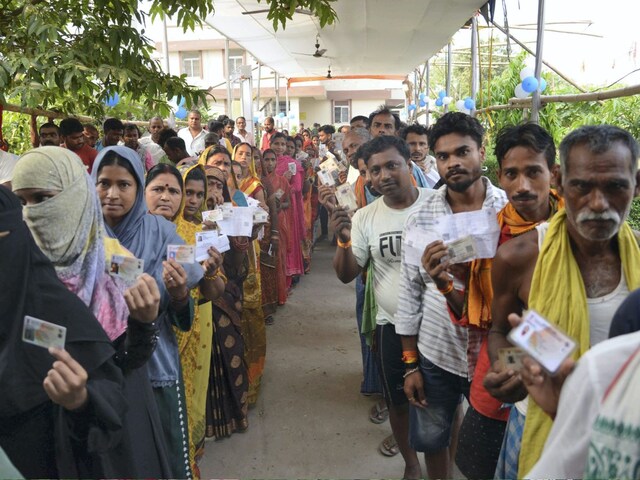 Voters show their ID cards as they wait to cast their vote for the fifth phase of the Lok Sabha elections, in Hajipur on May 20. (Image: PTI)
