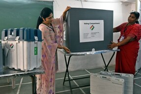 Election officials prepare a polling booth