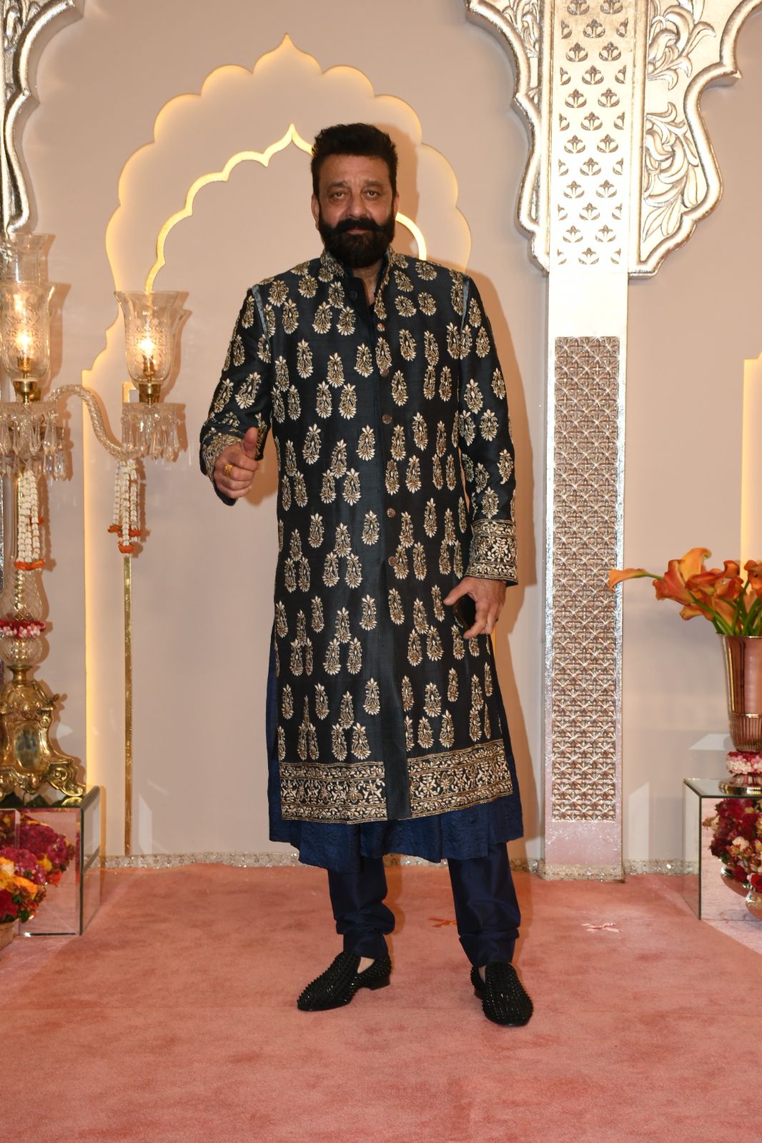 Sanjay Dutt opts for a gorgeous sherwani and beads-embroidered shoes as he does a thumbs-up pose for the paps. (Images: Viral Bhayani) Sanjay Dutt opts for a gorgeous sherwani and beads-embroidered shoes as he does a thumbs-up pose for the paps. (Images: Viral Bhayani)