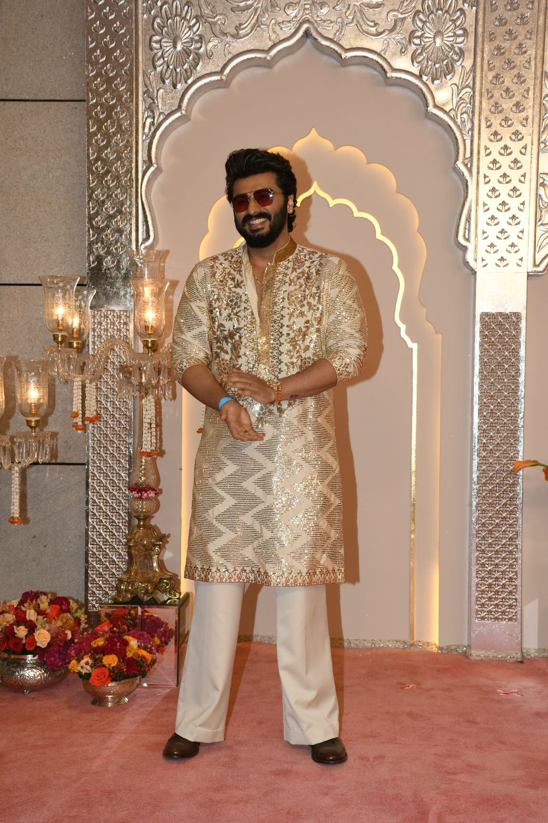 Arjun Kapoor can be called a handsome hunk in a shimmery golden kurta. His brown shades make the overall look cooler. (Images: Viral Bhayani) Arjun Kapoor can be called a handsome hunk in a shimmery golden kurta. His brown shades make the overall look cooler. (Images: Viral Bhayani)