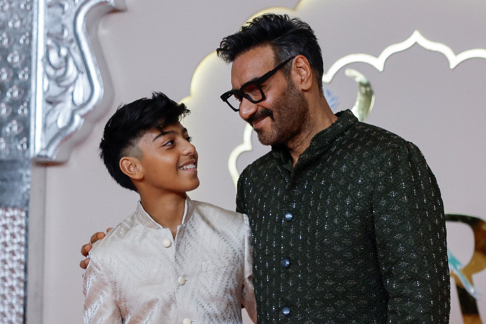 Ajay Devgn and Yug are father-son goals in contrasting black and silver sherwanis at Anant Ambani and Radhika Merchant's wedding party. (Image: Reuters) Ajay Devgn and Yug are father-son goals in contrasting black and silver sherwanis at Anant Ambani and Radhika Merchant's wedding party. (Image: Reuters)
