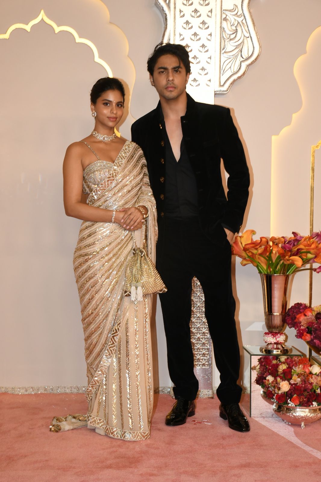 Suhana Khan and brother Aryan Khan look classy in contrasting outfits. Suhani is a desi girl in a golden designer saree and Aryan goes for a black blazer suit. (Image: Viral Bhayani) Suhana Khan and brother Aryan Khan look classy in contrasting outfits. Suhani is a desi girl in a golden designer saree and Aryan goes for a black blazer suit. (Image: Viral Bhayani)