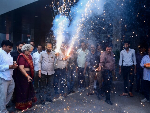 BJP workers burst crackers and dance as they celebrate the party's victory in Haryana Assembly polls on Tuesday. (PTI polls)
