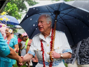 King Charles shakes hands with a local resident as he meets villagers and community groups involved in the reforestation efforts at O Le Pupu'Pue  Park, in Sa'agafou, Samoa, October 24. (Reuters)