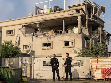 Israeli police men work at the site where projectiles fired from Lebanon hit a home in Tira, central Israel, Saturday, Nov. 2, 2024. (AP Photo)