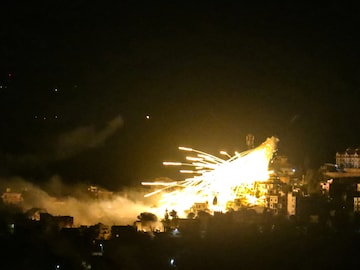 A picture taken from the area of Marjeyoun in southern Lebanon shows explosions over buildings in the town of Khiam, during Israeli bombardment on October 31, 2024. (AFP)