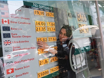 Currency exchange rates are displayed on a board as an employee works, as the Mexican peso has adjusted its position in recent weeks in anticipation of the U.S. election, in Mexico City, Oct 30. (Reuters)