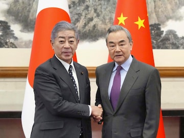 Japan's Foreign Minister Takeshi Iwaya with Chinese counterpart Wang Yi (AP Image)