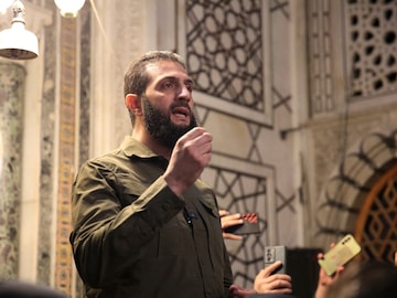 The leader of Syria's Islamist Hayat Tahrir al-Sham (HTS) group that headed a lightning rebel offensive snatching Damascus from government control, Abu Mohammed al-Jolani, address a crowd at the capital's landmark Umayyad Mosque (AFP)