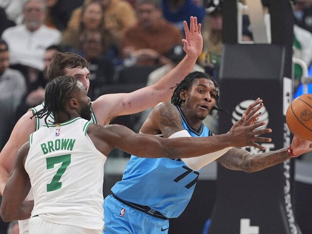 Los Angeles Clippers guard Kevin Porter Jr., right, tries to pass while under pressure from Boston Celtics forward Baylor Scheierman, left, and guard Jaylen Brown during the first half of an NBA basketball game, Wednesday, Jan. 22, 2025, in Inglewood, Calif. (AP Photo/Mark J. Terrill)   
