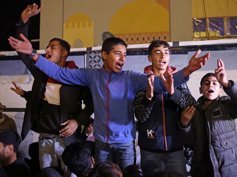 People celebrate while watching a television along a street in Khan Yunis in the southern Gaza Strip on January 15. (AFP photo) People celebrate while watching a television along a street in Khan Yunis in the southern Gaza Strip on January 15. (AFP photo)