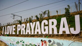 An artist paints a wall as part of preparations for Maha Kumbh Mela 2025, in Prayagraj, on Saturday, January 4, 2025. (PTI Photo)
