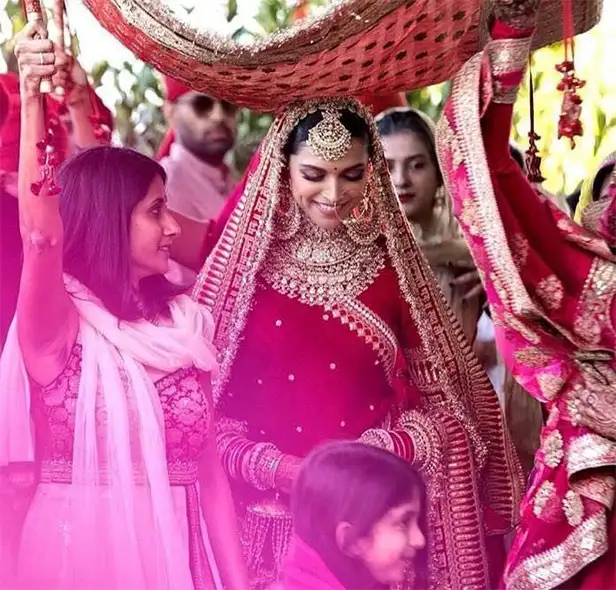  Deepika Padukone: Always Class Personified With a crimson lehenga embellished with peacock designs and the Sanskrit blessing 'Sada Saubhagyavati Bhava,' Deepika Padukone honoured her ancestry. Her outfit, which was layered with elaborate dupattas, exuded luxury and ethnic pride.