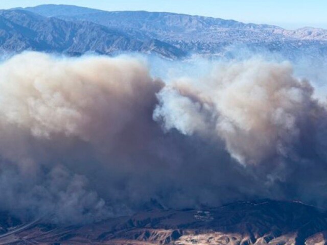  The fire was being fanned by strong, dry Santa Ana winds that were racing through the area. 