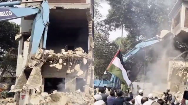 While Rehman’s house was being demolished, a man was seen waving a Palestinian flag. (Screengrab/ANI)