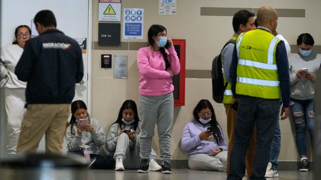 Colombian migrants deported from the United States wait inside El Dorado airport after arriving in Bogota, Colombia. (AP photo)