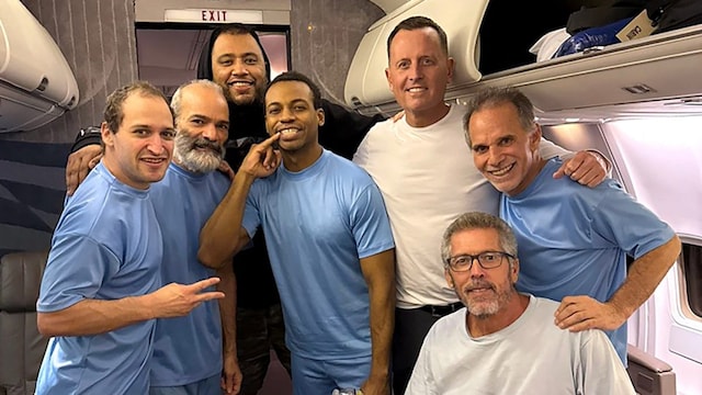 Trump's Special Missions Envoy Richard Grenell (3rd R) posing on board a plane alongside six US citizens released from detention in Venezuela.