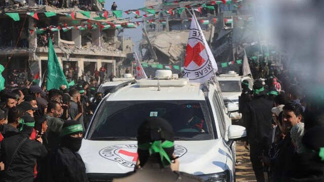 Palestinian Hamas militants and civilians gathering around a Red Cross convoy in Jabalia. (AFP file photo)