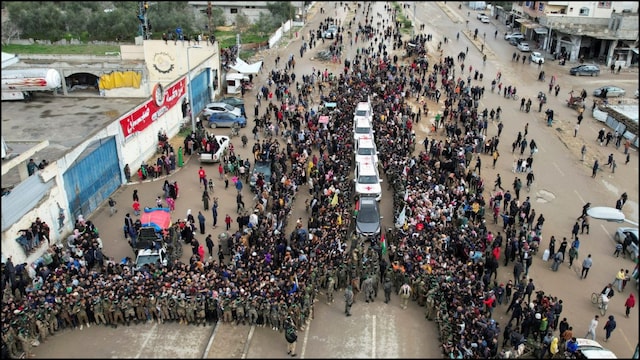 Palestinians and Hamas militants gathering around Red Cross vehicles on the day of the release  of Israeli hostages. (Reuters)