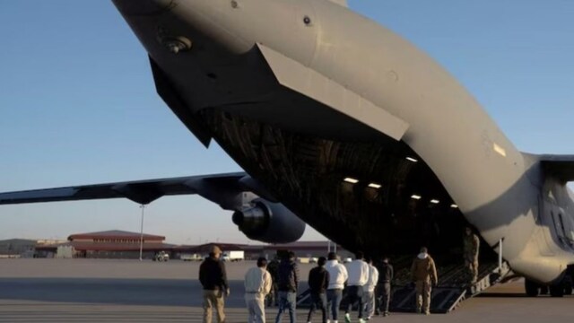 Detained migrants to boarding a US Air Force C-17 Globemaster III aircraft. (Reuters)