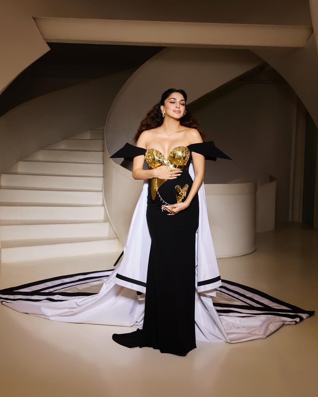 The Bollywood actress opted for a structured black gown with dramatic sharp sleeves. Her outfit was all about celebrating motherhood, strength and transformation. (Image: Instagram) The Bollywood actress opted for a structured black gown with dramatic sharp sleeves. Her outfit was all about celebrating motherhood, strength and transformation. (Image: Instagram)