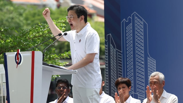 Singapore's Prime Minister Lawrence Wong speaks next to Senior Minister Lee Hsien Loong at a People's Action Party (PAP) lunchtime rally ahead of the general election (Reuters)