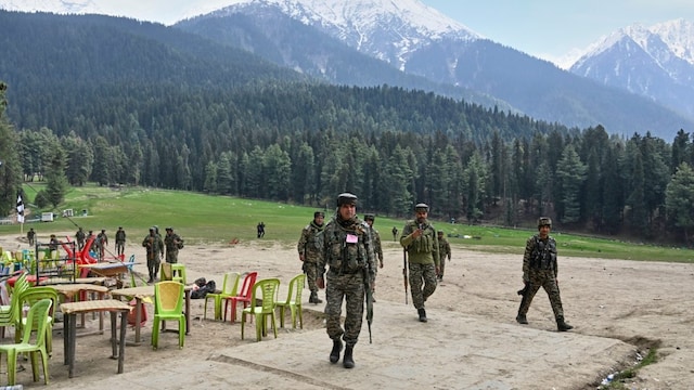 Security personnel inspect the site of a militant attack on tourists at Pahalgam in Jammu and Kashmir. (AP photo)
