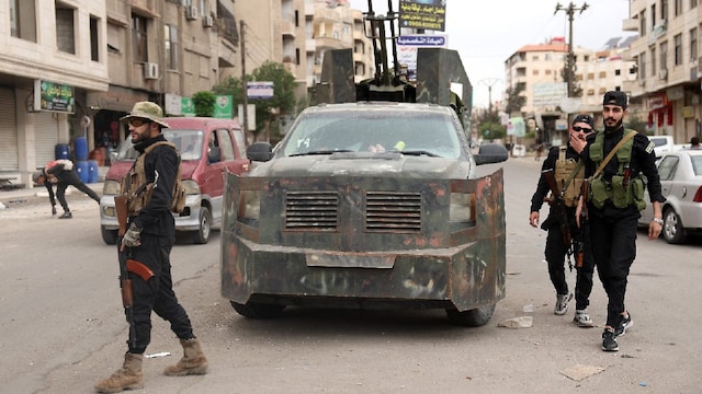 Members of Syria's security forces stand guard at a checkpoint in Ashrafiyat Sahnaya near Damascus on May 1, 2025. Syrian Druze spiritual leader Sheikh Hikmat al-Hijri on May 1, condemned what he called a "genocidal campaign" against his people, after two days of deadly sectarian clashes. (IMAGE: AFP)