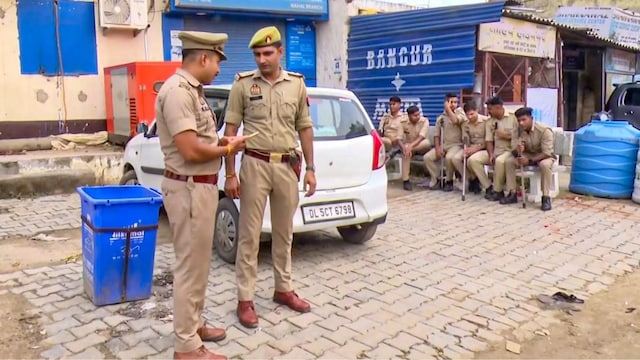 Police personnel stand guard after a constable who was shot dead by miscreants during a raid at Nahal village, in Ghaziabad district, Monday, May 26, 2025. (PTI)