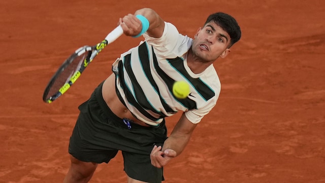 Carlos Alcaraz serves to Damir Dzumhur during their third-round match. (AP Photo)